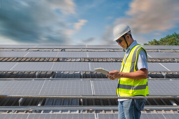 Engineers walking on roof inspect and check solar cell panel by hold equipment box and radio...