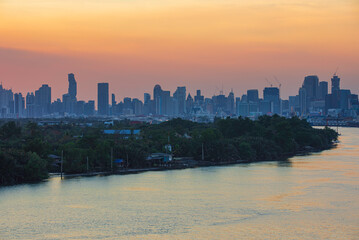 Cityscape at view evening from the river background sunlight orange