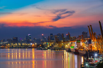Cityscape at view evening sunlight from the river cargo container import container ship in the...