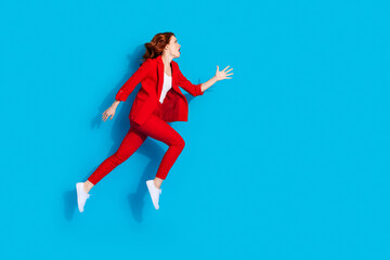 Photo of stressed depressed lovely girl wear red stylish clothes run empty space isolated on blue color background