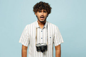 Traveler frowning sad mad Indian man wears white casual clothes look camera isolated on plain blue...