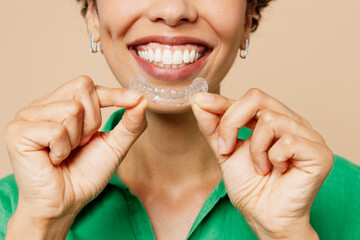 Close up cropped young woman of African American ethnicity wear green shirt casual clothes hold...