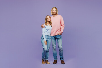 Full body smiling happy young satisfied couple two friends family man woman in pink blue casual clothes together looking camera isolated on pastel plain light purple color background studio portrait