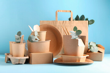 Eco friendly food packaging. Paper containers, tableware, bag and eucalyptus branches on white...