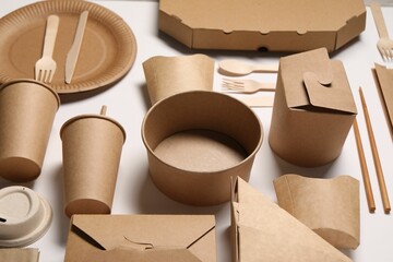 Eco friendly food packaging. Paper containers and tableware on white background