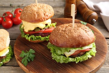 Delicious vegetarian burgers served on wooden table