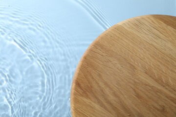 Wooden surface on light blue background, top view. Space for text