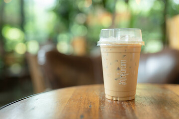 Dark coffee in  mug on wooden table..