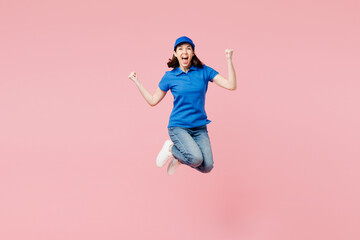 Full body excited delivery girl employee woman she wear blue cap t-shirt uniform workwear work as...