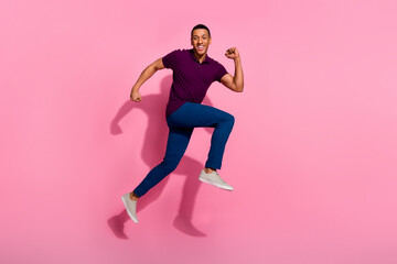 Fototapeta na wymiar Full size photo of attractive young man running black friday dressed stylish violet clothes isolated on pink color background