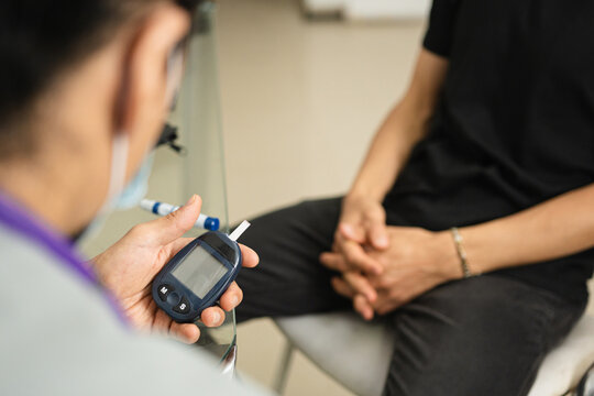 Doctor monitoring blood sugar levels for hypoglycemia