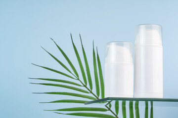 Blank Cosmetic Tubes with Green Leaf on Blue Background