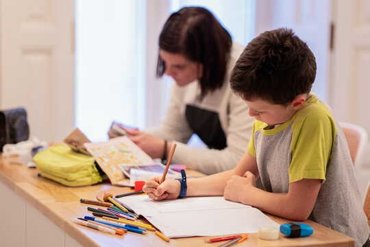 Siblings doing homework together at home
