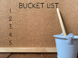 Bucket List text written on notice board with copy space background. Stock photo.