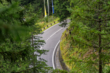Scenic landscape from hiking trail with aerial view of mountain pass road of Swiss Grimsel pass on a cloudy late summer day. Photo taken September 19th, 2023, Grimsel, Mountain Pass, Switzerland.
