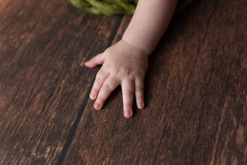 child's hand on a brown background. small fingers, children's manicure
