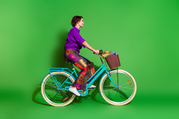 Profile photo of woman purple shirt and brown bob haircut riding bike in spring season delivery...