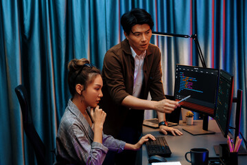 IT developers discussing with point to intelligent website development coder system running data...