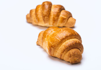 two fresh croissants on white background