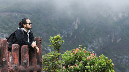 a man enjoying the fresh air and beautiful views in the misty Tangkuban Parahu mountain area © Harris Kharisma
