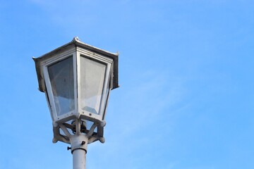 Street lamp in Yogyakarta with blue sky background. Old style metal electricity lamp