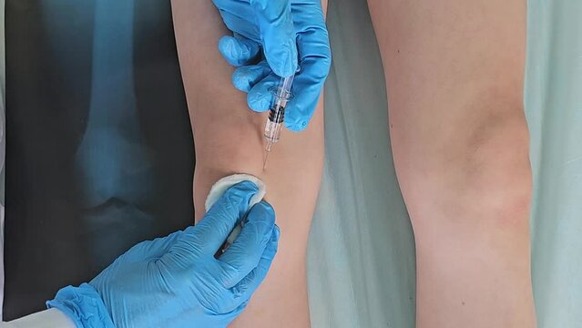 Person Receiving Knee Injection in Hospital