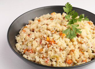 Rava Upma - Popular south Indian breakfast wiih semolina and vegetables, selective focus, Upma or upama is a South Indian breakfast
