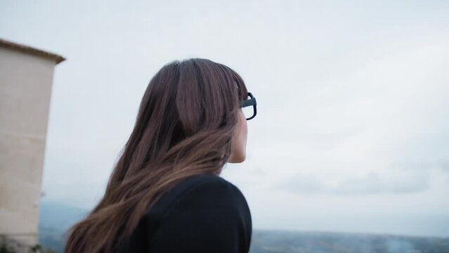 Woman Dressed In Black Looking Out From The Balcony Of Gerace