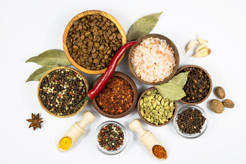 Assortment of spices and seasonings isolated on white background. Top view.