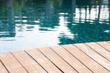 Outdoor swimming pool with wooden deck at resort