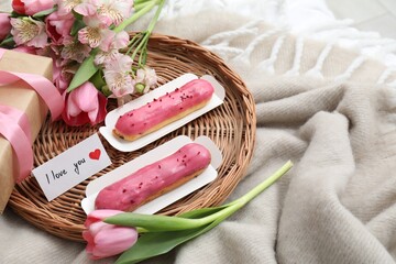 Tasty breakfast served in bed. Delicious eclairs, tea, flowers, gift box and card with phrase I...