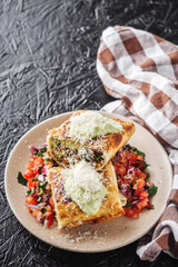 set of delicious fresh colorful deep-fried chimichanga on a dark background