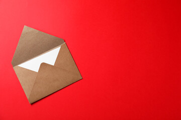 Letter envelope with card on red background, top view. Space for text