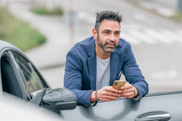 businessman with car and mobile phone