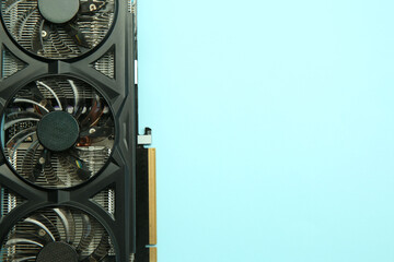 One graphics card on light blue background, top view. Space for text