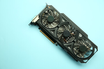 One graphics card on light blue background, top view. Space for text