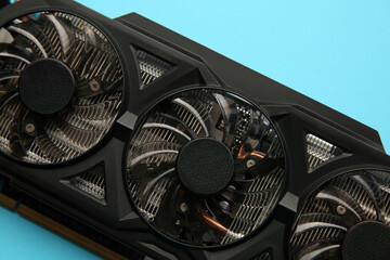 One graphics card on light blue background, top view