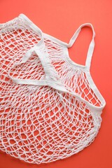 Obraz premium White string bag on red background, top view