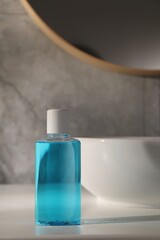 Bottle of mouthwash on light countertop in bathroom