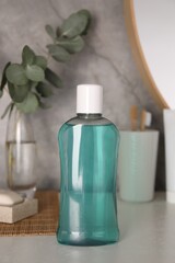 Bottle of mouthwash on light table in bathroom