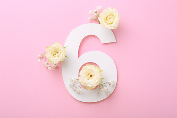 Paper number 6 and beautiful flowers on pink background, flat lay