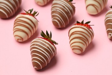 Delicious chocolate covered strawberries on pink background, closeup