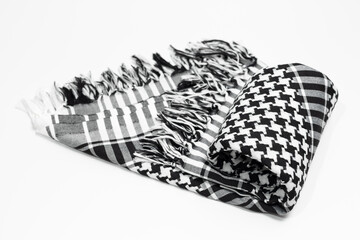 Keffiyeh, hijab, kandura, kufiyah or pushi, head covering commonly used in the Middle East and the Arab World. Keffiyeh is a traditional pattern garment tied to the head.