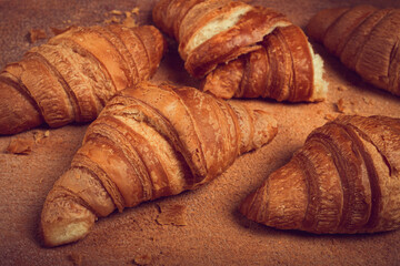 fresh croissants, breakfast, top view, on the table, brown background, no people,