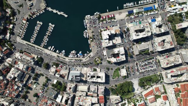 Experience the breathtaking beauty of Kavala, Greece from above, as sailboats gracefully glide through the marina waters, surrounded by stunning architecture and vibrant city life