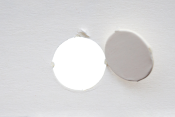 Torn ripped paper hole isolated on white background