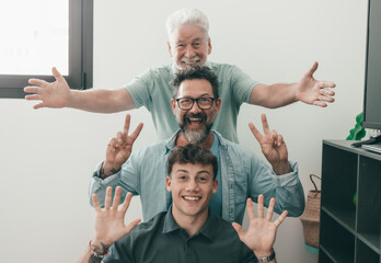 Happy multigenerational family of males stay together posing on scale for memory gesturing positive...