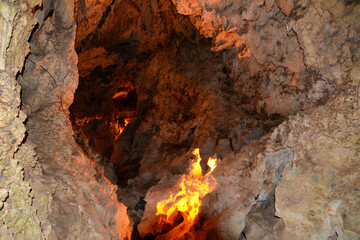 a cave with a fire inside of it