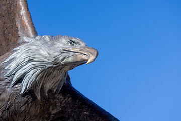 Huge bronze eagle against blue sky