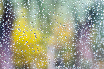 Raindrops on window glass in autumn